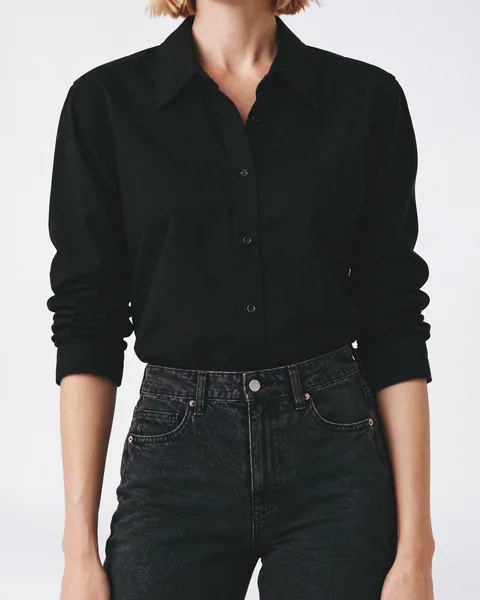 Product page photo: a detailed close-up of the black button-up shirt tucked into washed black jeans